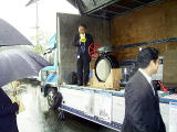 車の荷台で説明している写真